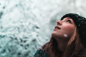 woman looking at the sky in winter